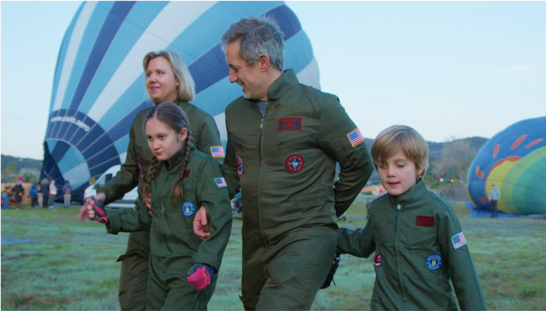 Magnolia sitting on a horse with her family—her parents, Jenny and AJ, and her brother, Grayden.