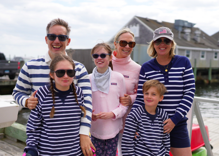 Two families gathered together before an adaptive sailing adventure