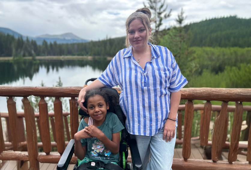 Mother and daughter smiling before an adaptive ropes course