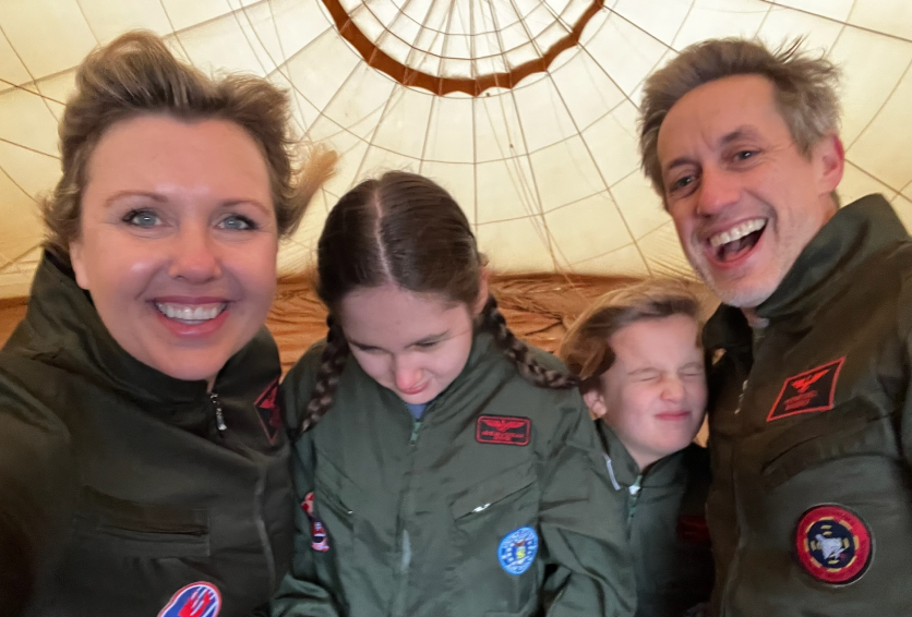 Family posing together before a hot air balloon adventure