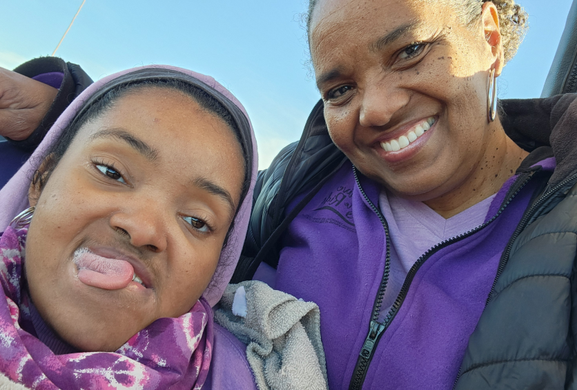 Mother and daughter smiling inside a hot air balloon basket